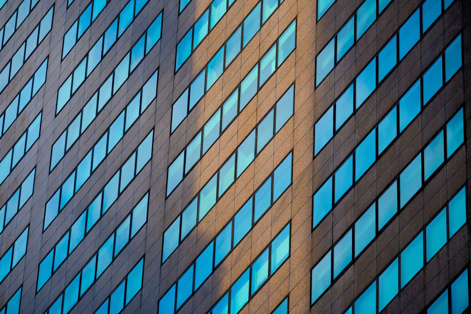 A glass facade reflecting the Knoxville sky